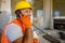 Smiling young construction specialist working in plant