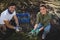 Smiling young couple collecting olives at farm