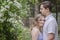 Smiling young couple hugging under flower arch