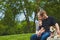 Smiling young couple patting their dog outdoor