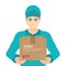 Smiling young delivery man in blue cap standing with parcel post box