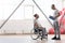 Smiling young disabled patient having conversation with his physical therapist