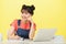 Smiling young ethnic student at desk