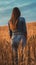 smiling young female farmer cowgirl standing in wheat cereal field. copy space