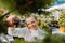 Smiling young female gardener is pruning green bush. Gardening tools concept