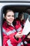 smiling young female paramedic holding clipboard and looking