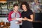 Smiling young friend using digital tablet in restaurant