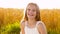 Smiling young girl on cereal field in summer