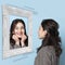 Smiling young girl looking at mirror isolated on light background. Contemporary art collage. Concept of emotions, inner