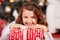 Smiling young girl with a red Christmas present