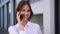 Smiling young girl talking on the mobile phone.Business woman answers phone call
