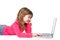 Smiling young girl typing on laptop