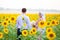 Smiling young islamic couple portrait on sunflowers field