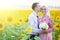 Smiling young islamic couple portrait on sunflowers field. Muslim marriage