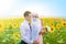 Smiling young islamic couple portrait on sunflowers field. Muslim marriage