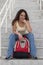 Smiling Young Latina Student with Backpack on stairs