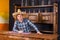 Smiling young man as bartender in a sombrero leaned on bar count