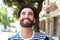 Smiling young man with beard looking up