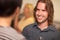 Smiling Young Man with Glass of Wine Socializing