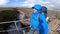 Smiling Young man hikes through rough Iceland terrain during strong wind up to 30 meters per second on the Fimmvorduhals