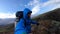 Smiling Young man hikes through rough Iceland terrain during strong wind up to 30 miters per second on the Fimmvorduhals