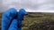 Smiling Young man hikes through rough Iceland terrain during strong wind up to 30 miters per second on the Fimmvorduhals