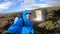 Smiling Young man hikes through rough Iceland terrain during strong wind up to 30 miters per second on the Fimmvorduhals