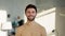 Smiling young man indoors at home looking camera