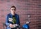 Smiling young man sitting on a blue motorbike