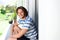 Smiling young man sitting on patio outside