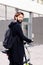 Smiling young man walking with a folding bike