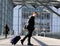 Smiling young man walking with luggage at station