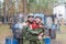 Smiling young man and woman posing with paintball markers outdoors