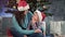 Smiling young mother and little cute child hugging sitting together and talking near Christmas tree