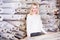 Smiling young seller showing wide assortment at textile shop