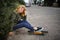 Smiling Young Teenage Girl With A Skateboard Sitting on the curb