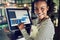 Smiling young waitress using a restaurant point of sale terminal