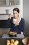 Smiling young woman baking apple tart