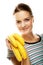 Smiling young woman with banana