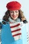 Smiling young woman with blue shopping bag checking purchases