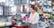 Smiling young woman buying ware for wine bottle in cookware shop