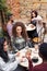 Smiling young woman chatting with friends in a cafe courtyard