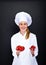 Smiling young woman chef with tomatos juggle