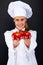 Smiling young woman chef with tomatos juggle