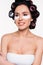smiling young woman in curlers with