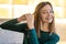 Smiling young woman demonstrating hairstyling tips