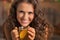 Smiling young woman drinking ginger tea with lemon