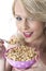 Smiling Young Woman Eating Breakfast Cereals