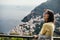 Smiling young woman enoying seaview in Positano,Italy. Vacation on Amalfi coast.Happy tourist in Europe.Italian coast beauty,