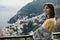 Smiling young woman enoying seaview in Positano,Italy. Vacation on Amalfi coast.Happy tourist in Europe.Italian coast beauty,